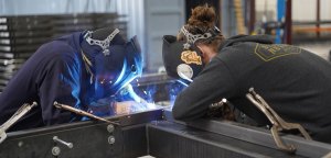 Two PUI employees welding